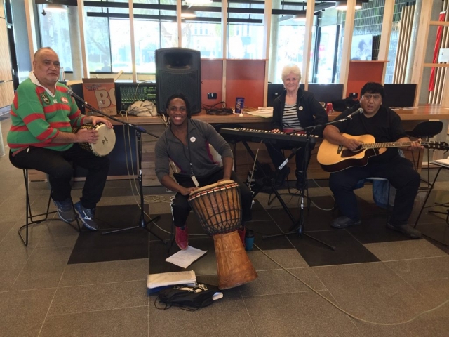 Four people playing musical instruments